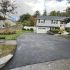 Freshly paved asphalt driveway in Lynn Massachusetts in front of a residential home