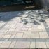 The evolution of paving materials from cobblestones to modern concrete pavers shown in a finished paved patio surface