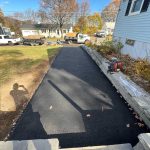 signs driveway needs resurfacing replacement mdz New asphalt driveway installation showing smooth resurfaced driveway by professional paving contractor MDZ Crew Landscaping