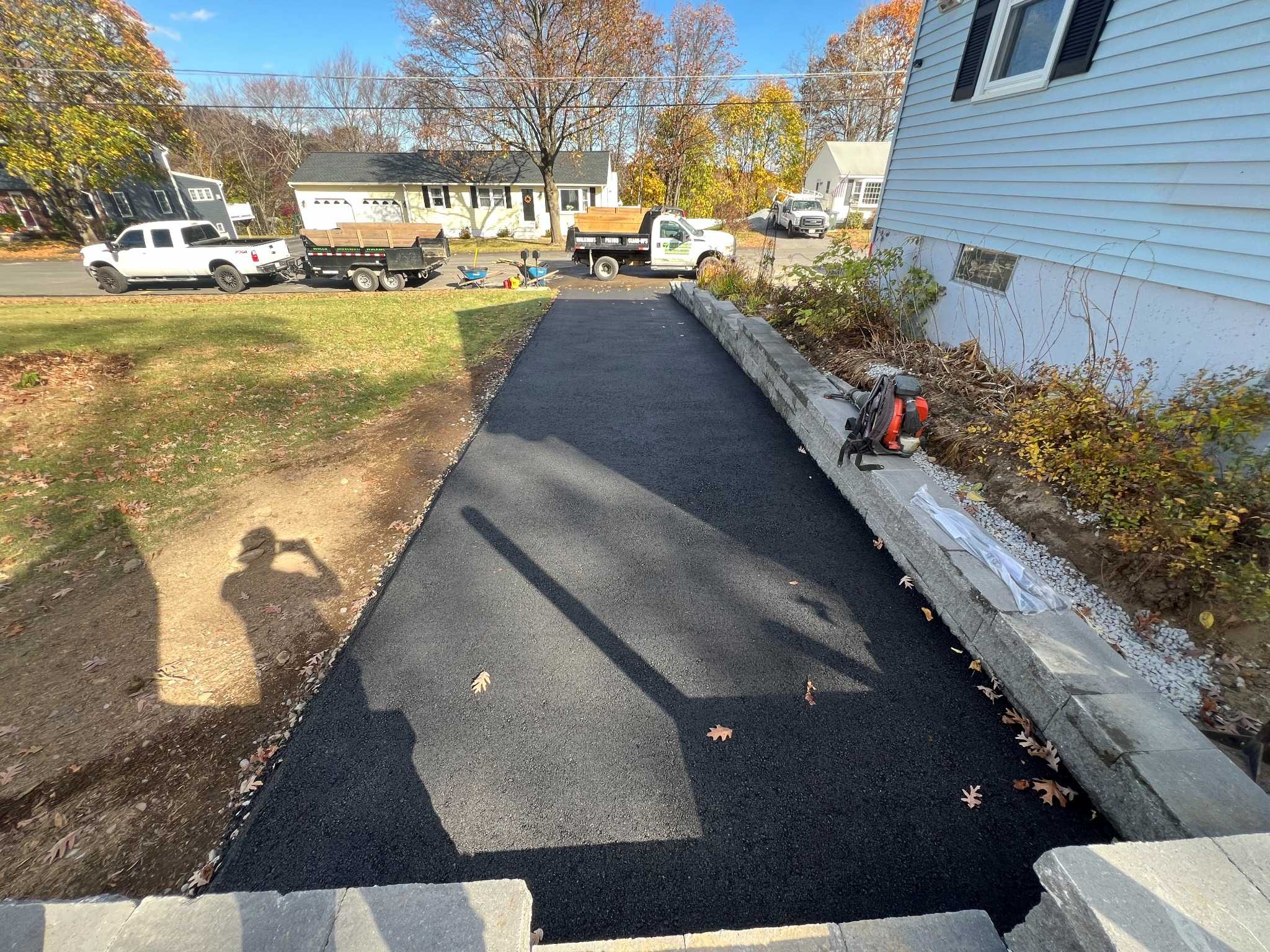New asphalt driveway installation showing smooth resurfaced driveway by professional paving contractor MDZ Crew Landscaping