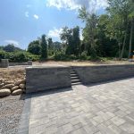 best time to hire paving contractor driveway project newly paved driveway with retaining wall showing ideal weather for paving contractor work