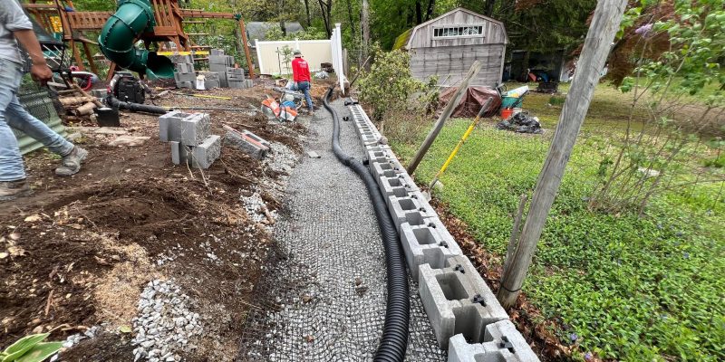 Professional landscape drainage installation project designed to protect residential property from water damage
