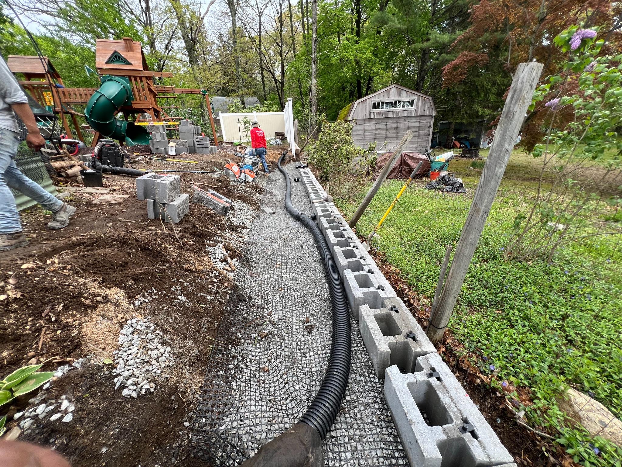 Professional landscape drainage installation project designed to protect residential property from water damage