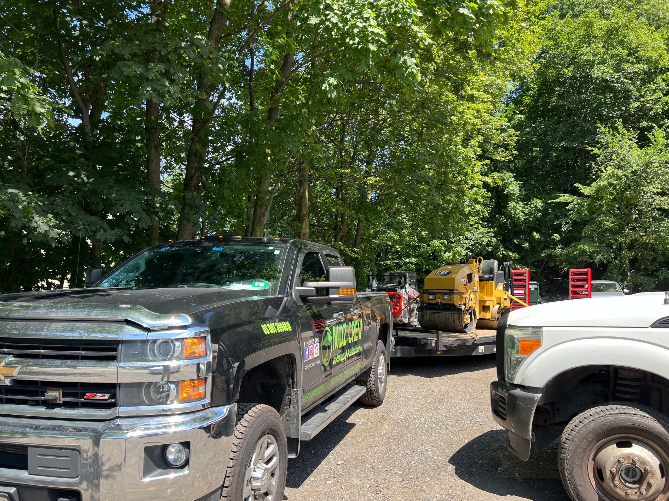 Professional licensed paving contractor truck and paving equipment on residential job site
